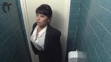 Vintage brunette in restaurant restroom